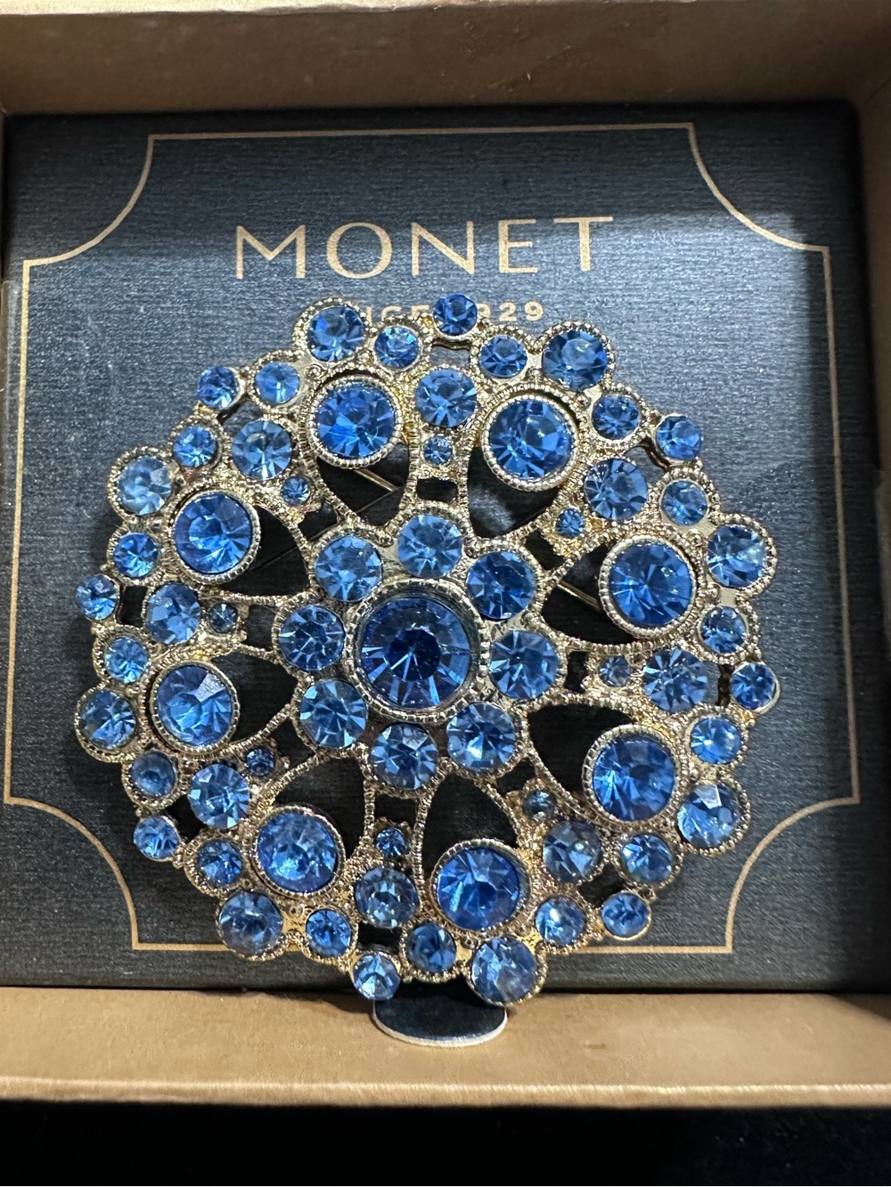 424-  Monet brooch featuring round blue rhinestones in box